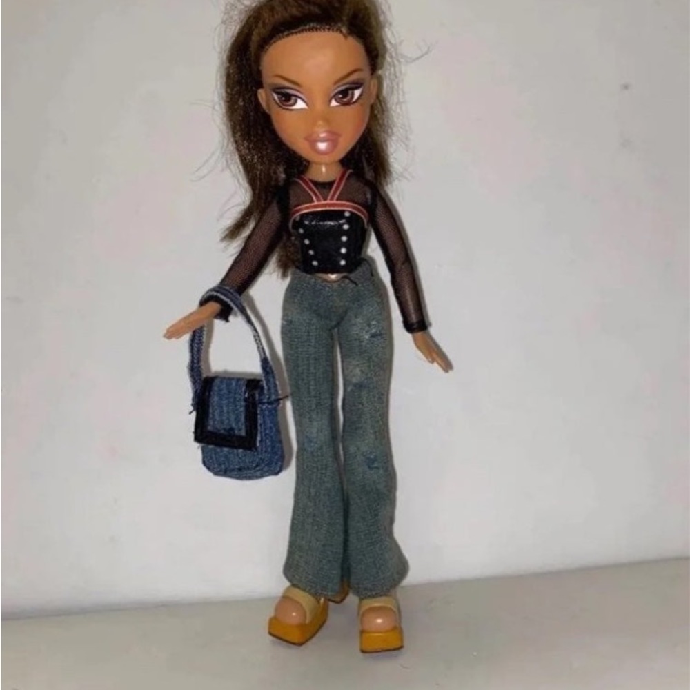 Bratz doll wearing lacy top . Jeans and boots. Rare